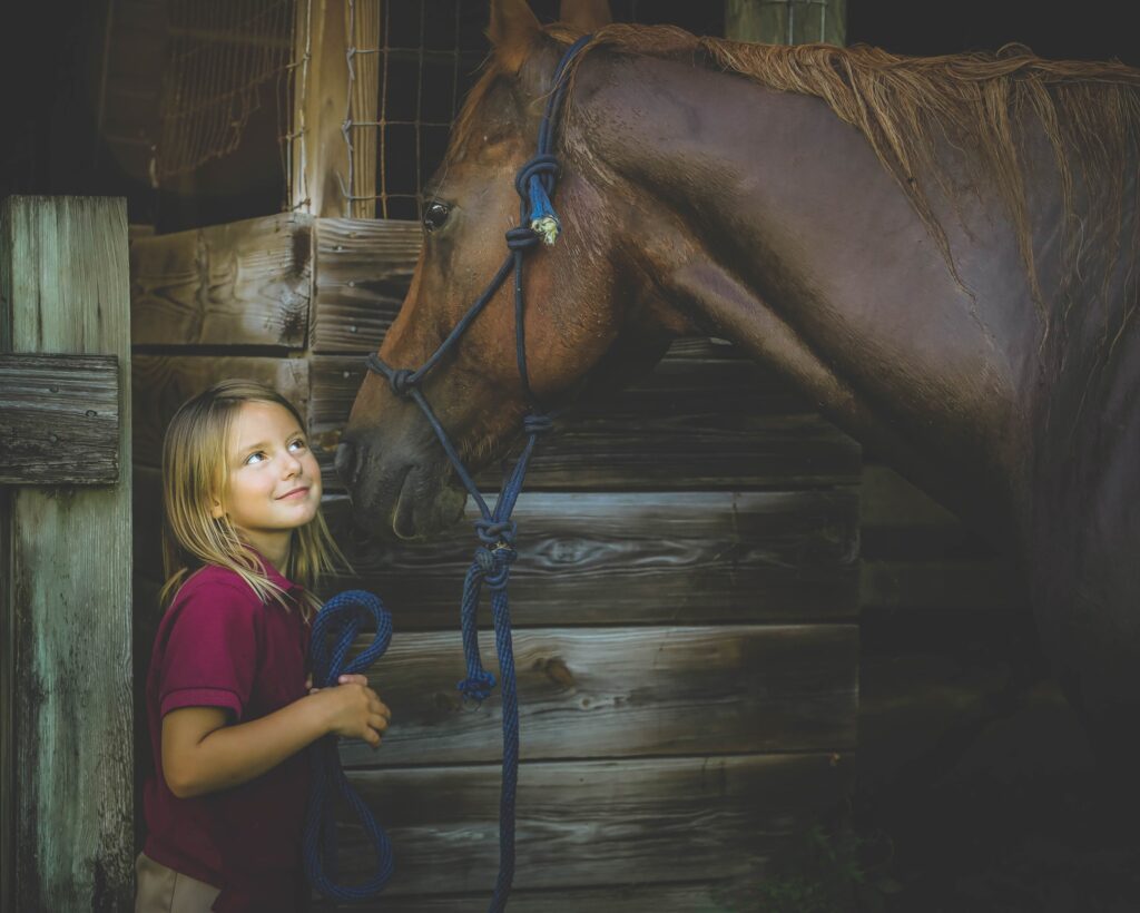 girl smiling at horse