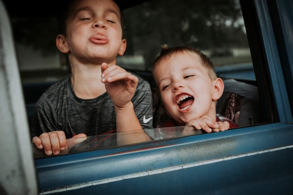 kids making faces in car