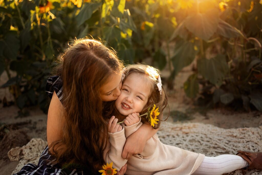 sisters in sunflower field