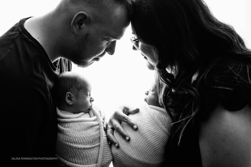 newborn twins with parents