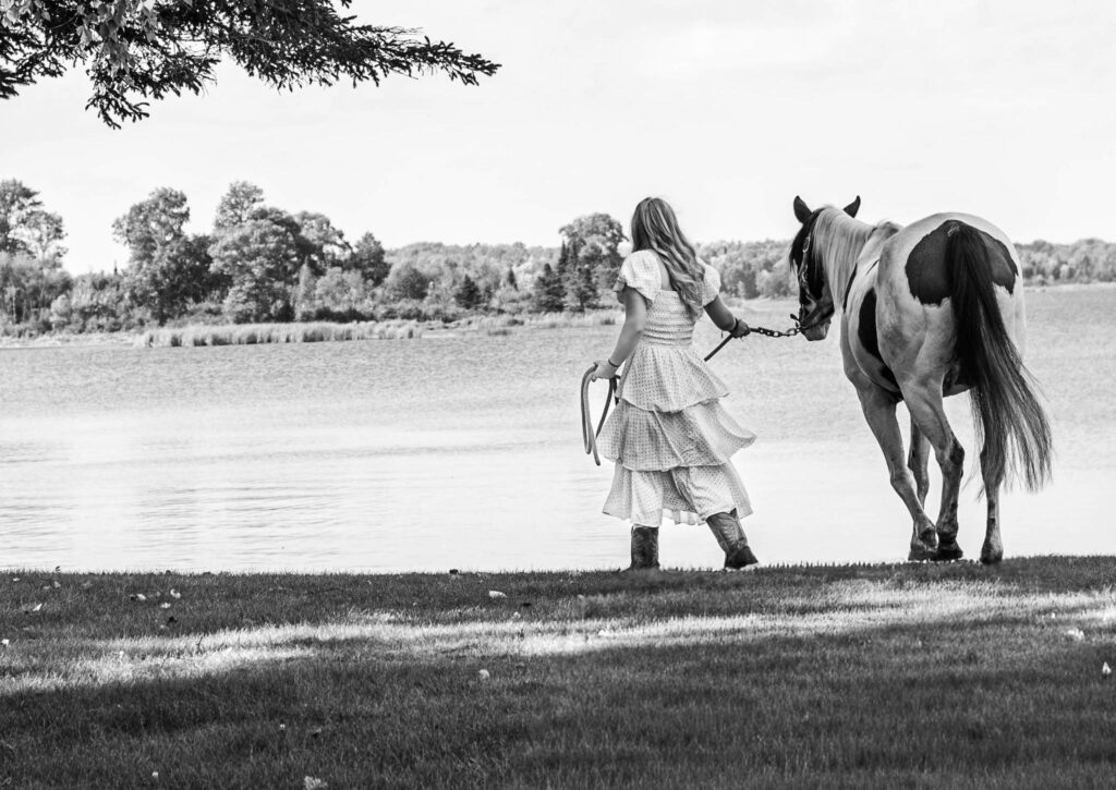 young women walking away with horse