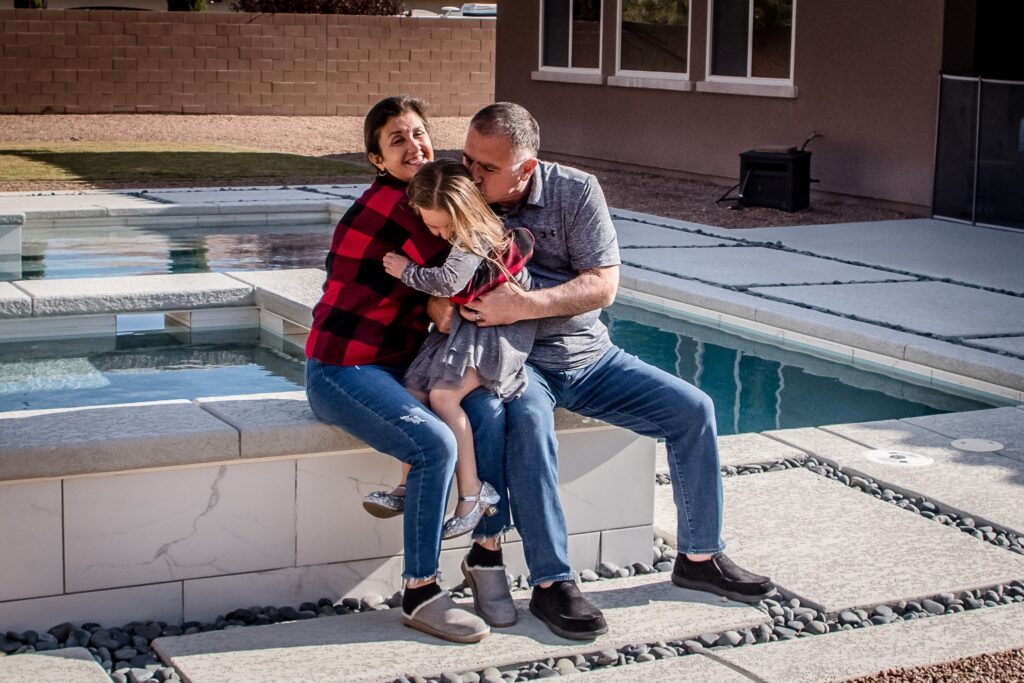 family of three hugging