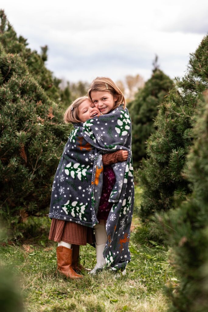 winter scene with siblings hugging andd smiling