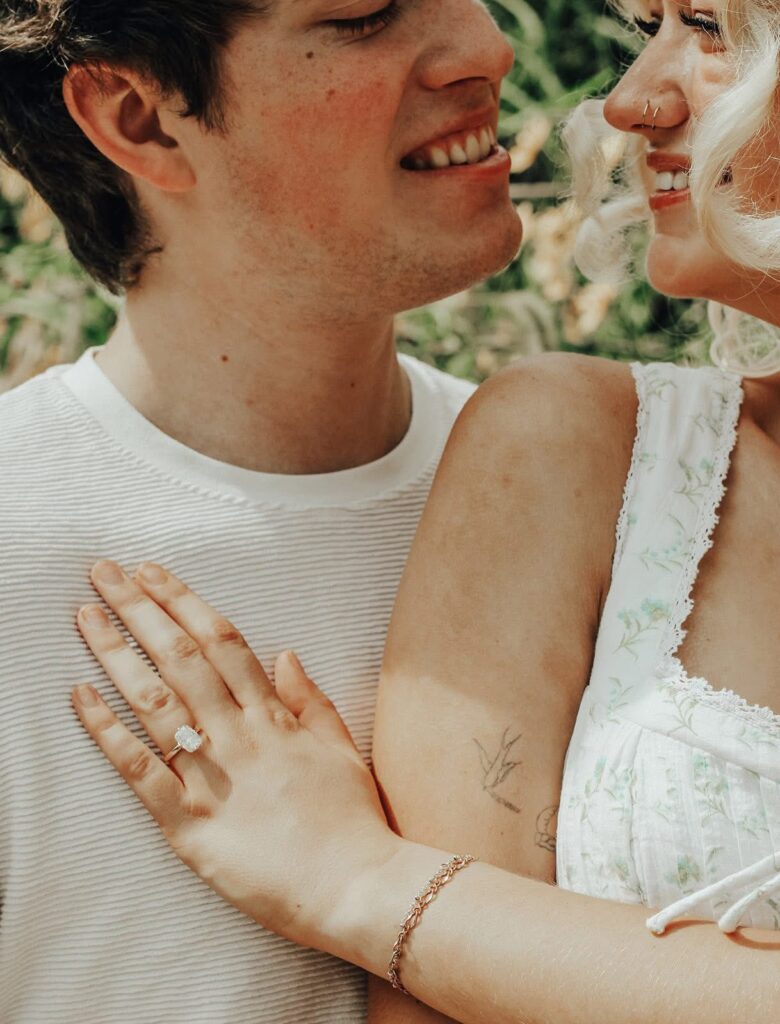 engagement couple looking at each other and showing off ing to camera