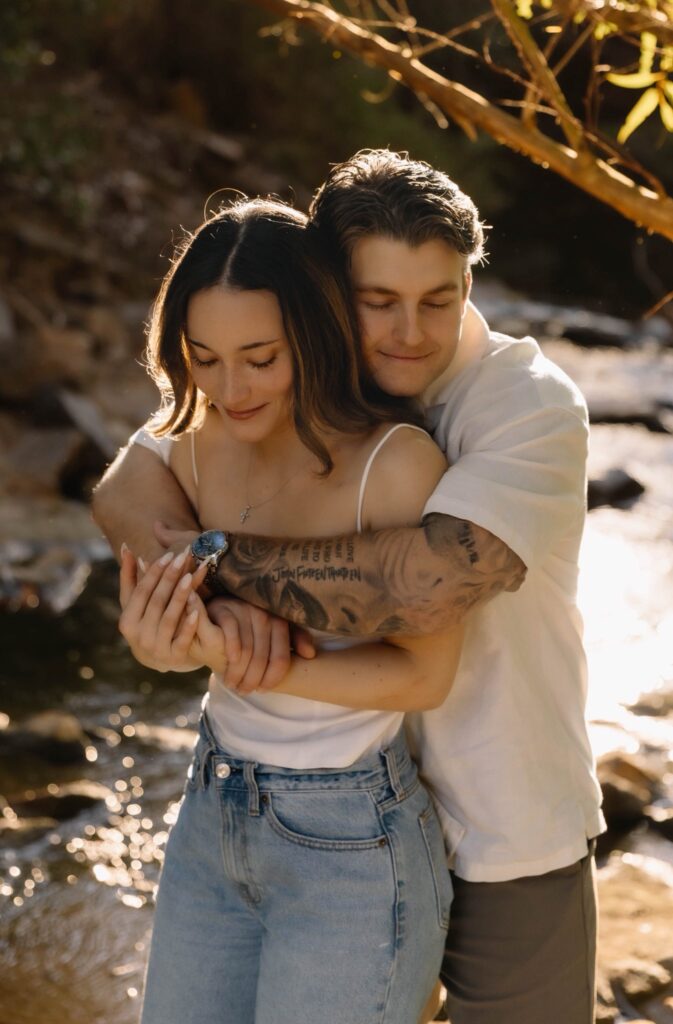 engagement couple hugging with eyes closed