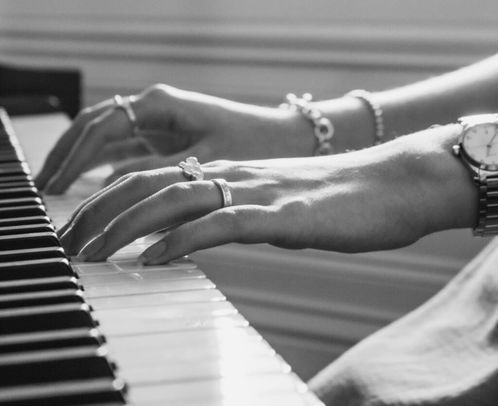an image of a pair of hands playing the piano