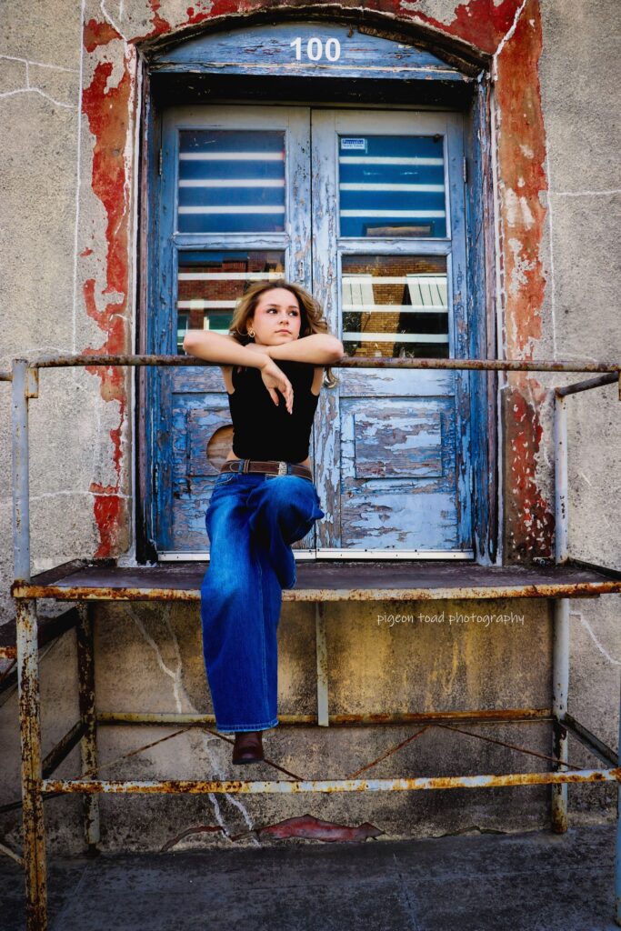 girl sitting in an urban scene with blue and red textures in background