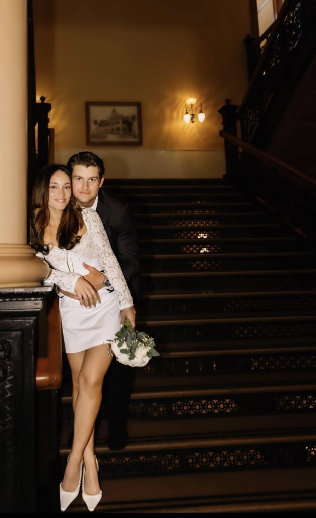 bride and groom posing for the camera and smiling