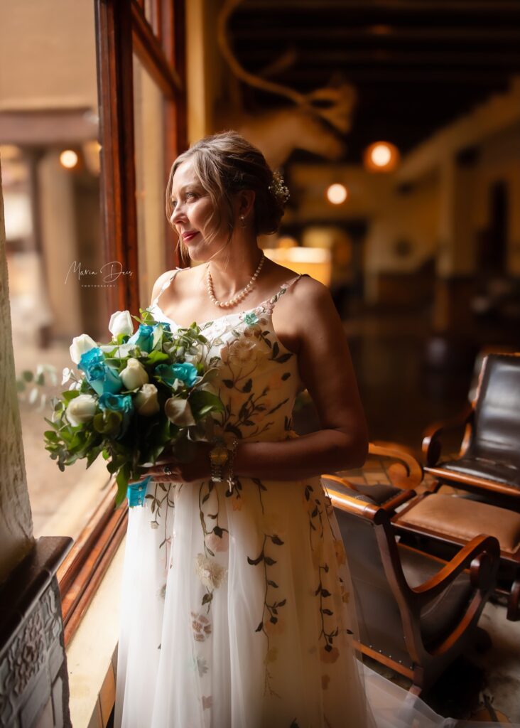 bridal portrait standing next to a window and gazing outside