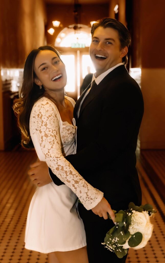 bride and groom smiling back at the camera